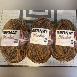 3 Skeins Bernat Blanket Yarn in Brown/Tan and olive green.